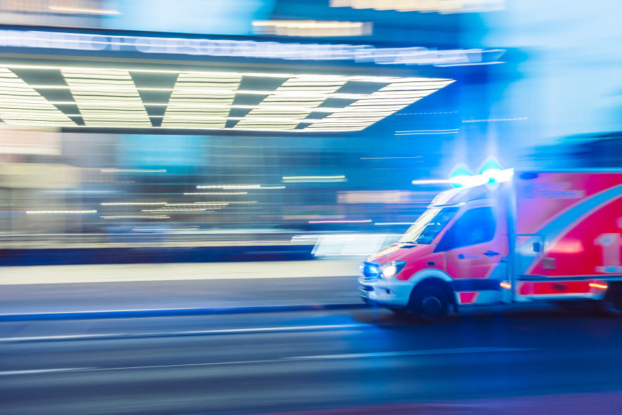 Ambulance speeding on a road to the hospital